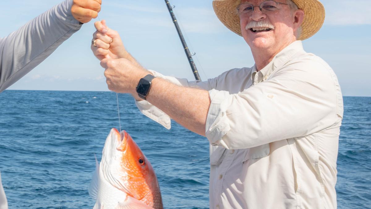Congressman Rutherford catches a red snapper off the coast of St. Augustine