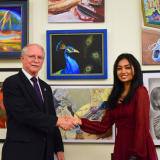 Congressman Rutherford is pictured with First Place Winner, Ashvatha Arun, alongside her winning artwork, "Eye of the Era."