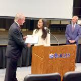 Congressman John Rutherford presenting Sarah Park with the certificate for first place in the Congressional App Challenge Competition.